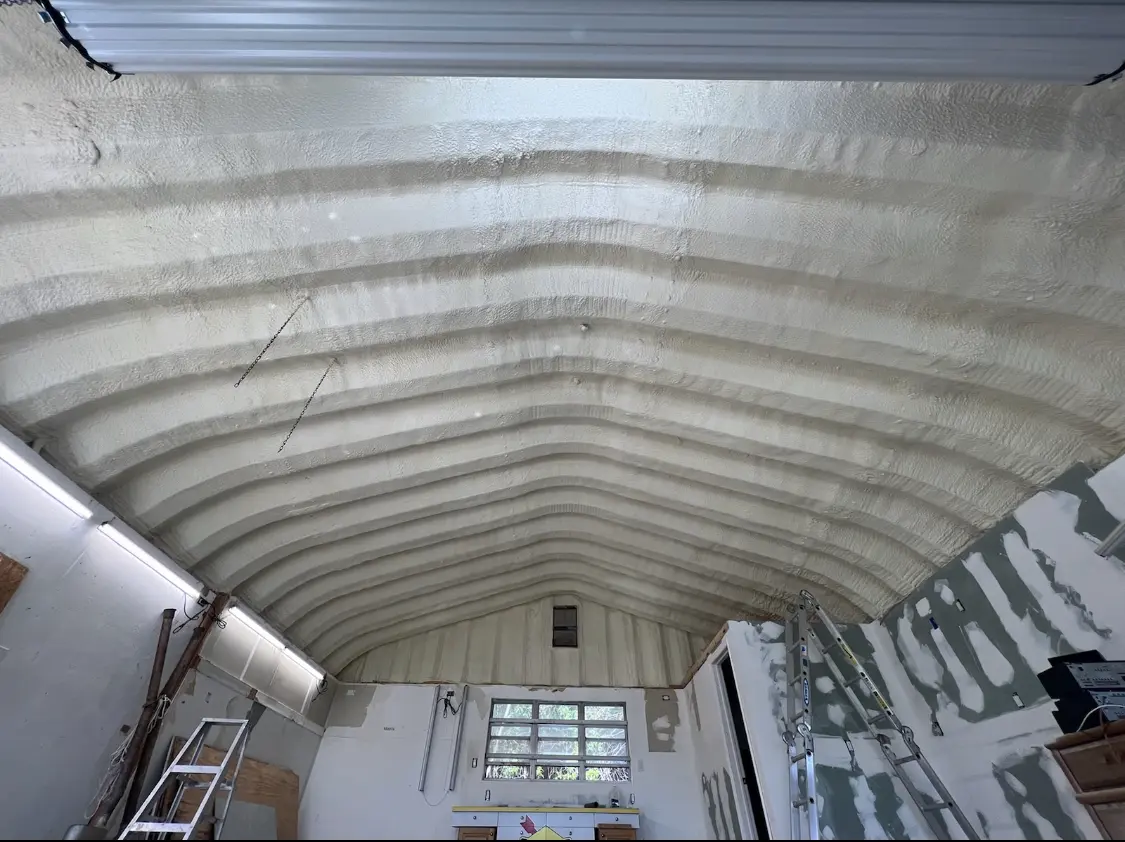 Spray polyurethane foam applied to the underside of a metal roof deck in Muskegon